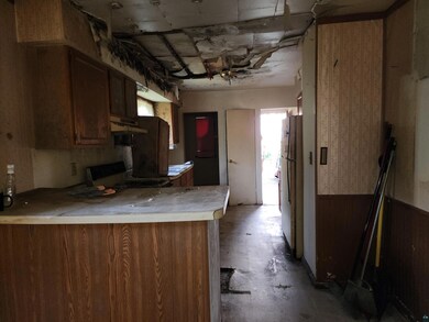 Kitchen featuring range, kitchen peninsula, fridge