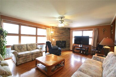 Large living room with big picture windows and woo