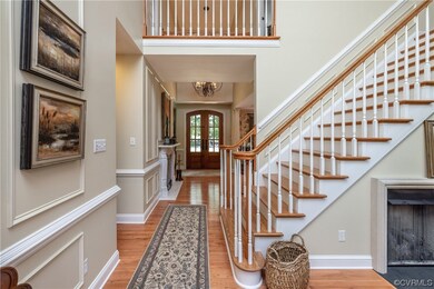 Wood floored entrance foyer featuring french doors