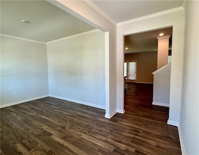 Empty room with crown molding, dark wood-type flooring, and recessed lighting