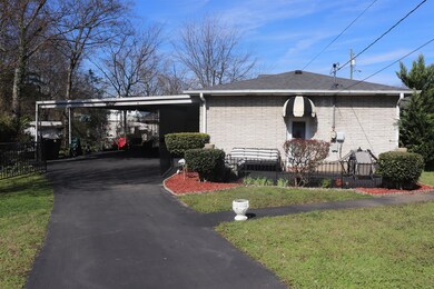 Side of home with 2 vehicle carport