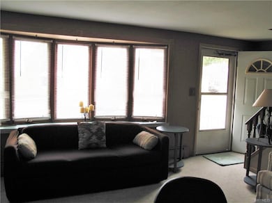 Well lit living room with open floor plan to kitch