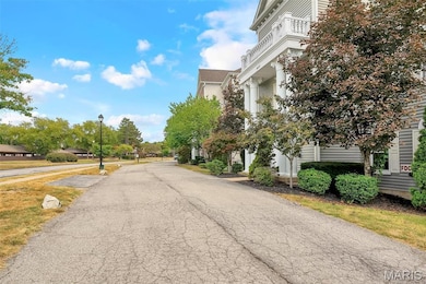 View of asphalt road featuring street lights