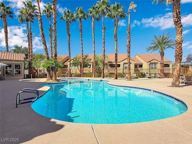 Community pool with a residential view and a patio area