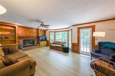 fireside great room opens out to expandsed deck overlooking private backyard