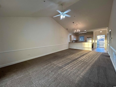 Unfurnished living room with dark colored carpet, 