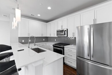 Kitchen with white cabinetry, stainless steel appl