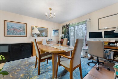 Dining room features newer laminate floors, chande