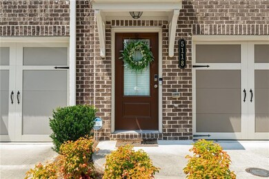 View of exterior entry with brick siding