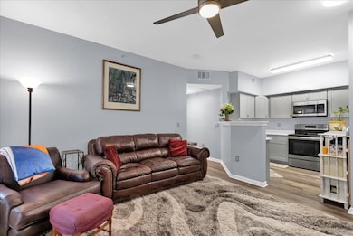 Living room with light wood-style floors and a ce