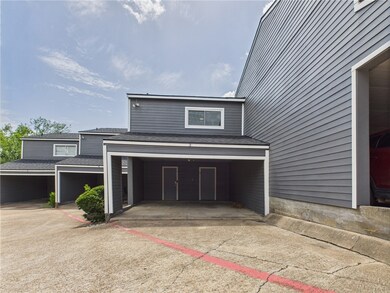 View of side of property with concrete driveway