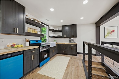 Kitchen featuring electric range, open shelves, di