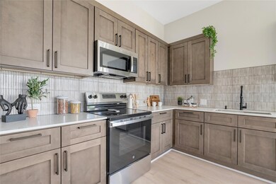 Kitchen featuring appliances with stainless steel