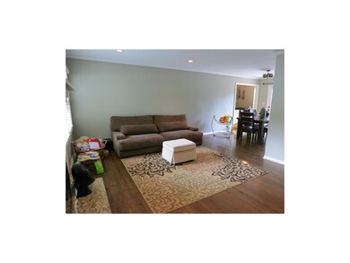 The gleaming hardwood floors continue to the forma