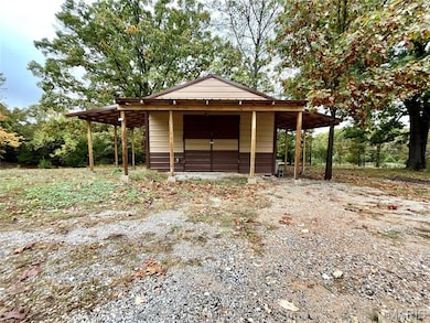 View of pole building with a carport