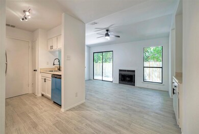 Kitchen with dishwasher, light countertops, and h