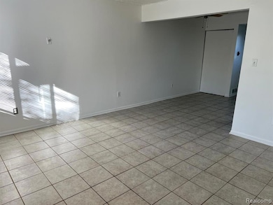 Unfurnished room with light tile patterned floors and ceiling fan