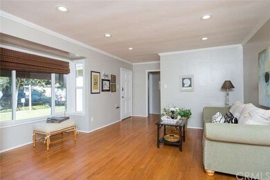 Living room with hardwood floors, crown molding an