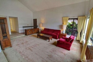 Living room and hallway in back leading to 4 bedro