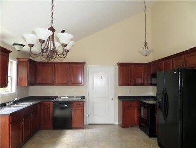 Open Country Kitchen with all Black Appliances 