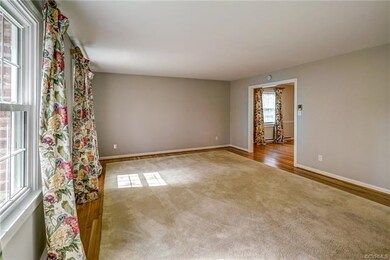The formal living room is accessed by the foyer an