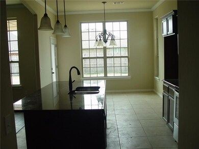 View from the laundry room into the kitchen and di