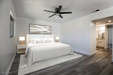 Bedroom featuring ceiling fan, dark wood-type floo