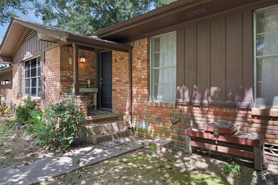 View of exterior entry featuring brick siding and board and batten siding