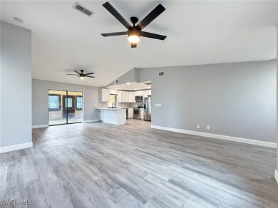Unfurnished living room featuring ceiling fan, vau