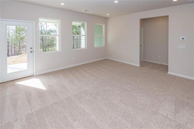 Spare room featuring carpet floors, baseboards, and recessed lighting