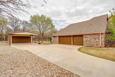 Shop, with covered carport, is just off driveway from garage.