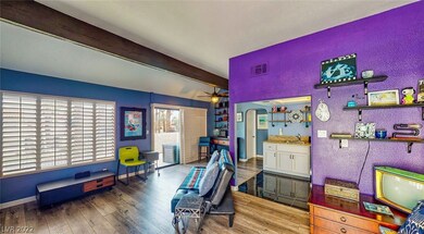 open style living with rustic beam, shutters and L