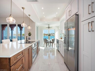 Kitchen with white cabinets, ceiling fan, pendant 