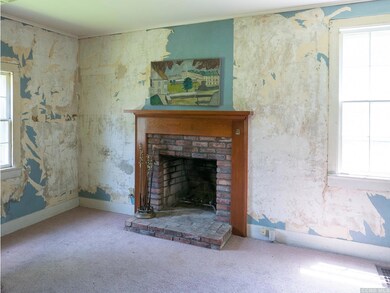 Den or study with wood burning fireplace. Could be