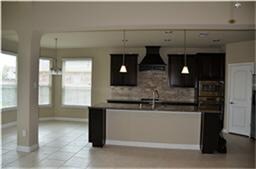 Spacious kitchen with large island and breakfast bar.