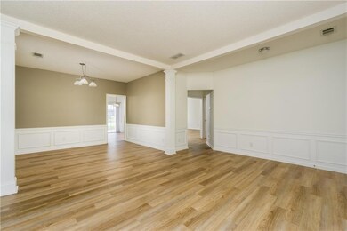 Unfurnished room with light wood-style floors, orn