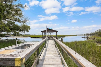 Dock area with a gazebo, a water view, and sink