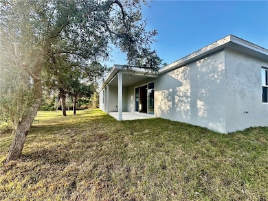 Back of property with a patio and a lawn