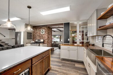 Fully remodeled kitchen with handmade butcher block counters and quartz penninsula.