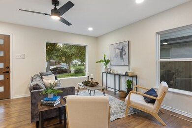 Living area featuring wood finished floors, a ceiling fan, and recessed lighting
