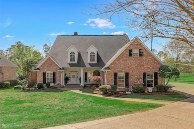 New england style home with a front lawn, brick si