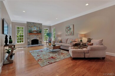 Spacious family room with stone gas fireplace, har
