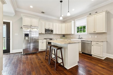 Kitchen has Granite Counters, Back Splash, Wood Fl