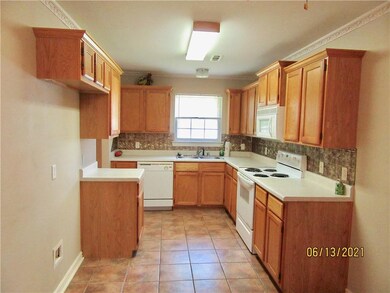 Kitchen has laminate countertops and crown molding
