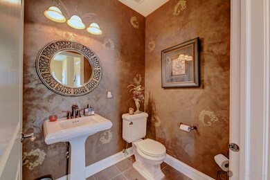 Separate powder room on the main level with custom