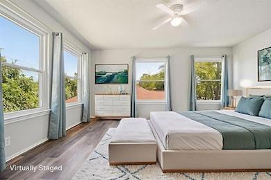 Bedroom with wood finished floors and a ceiling fan
