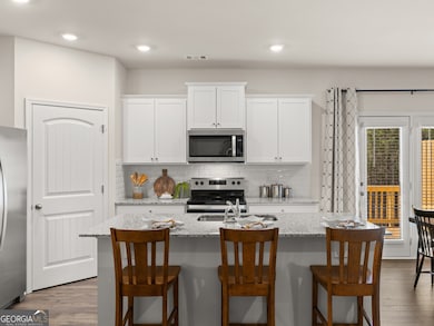 sudbury townhome kitchen with white cabinets and granite countertops at mountain park in dahlonega georgia