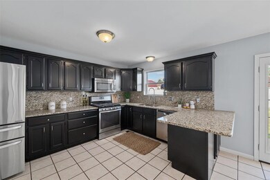 Kitchen has ceramic tile flooring, cabinets with c