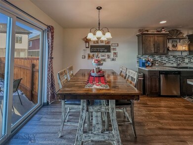 Dining space with dark hardwood / wood-style floor