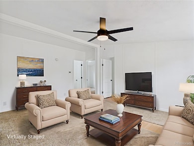 Comfortable living room with ceiling fan and built-in light for added ambiance...